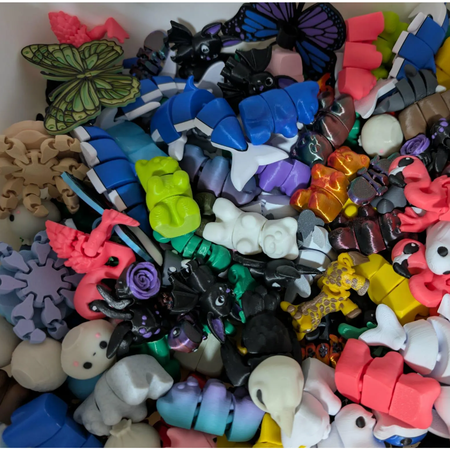 Assorted colorful rubber band charms including animals and butterflies.