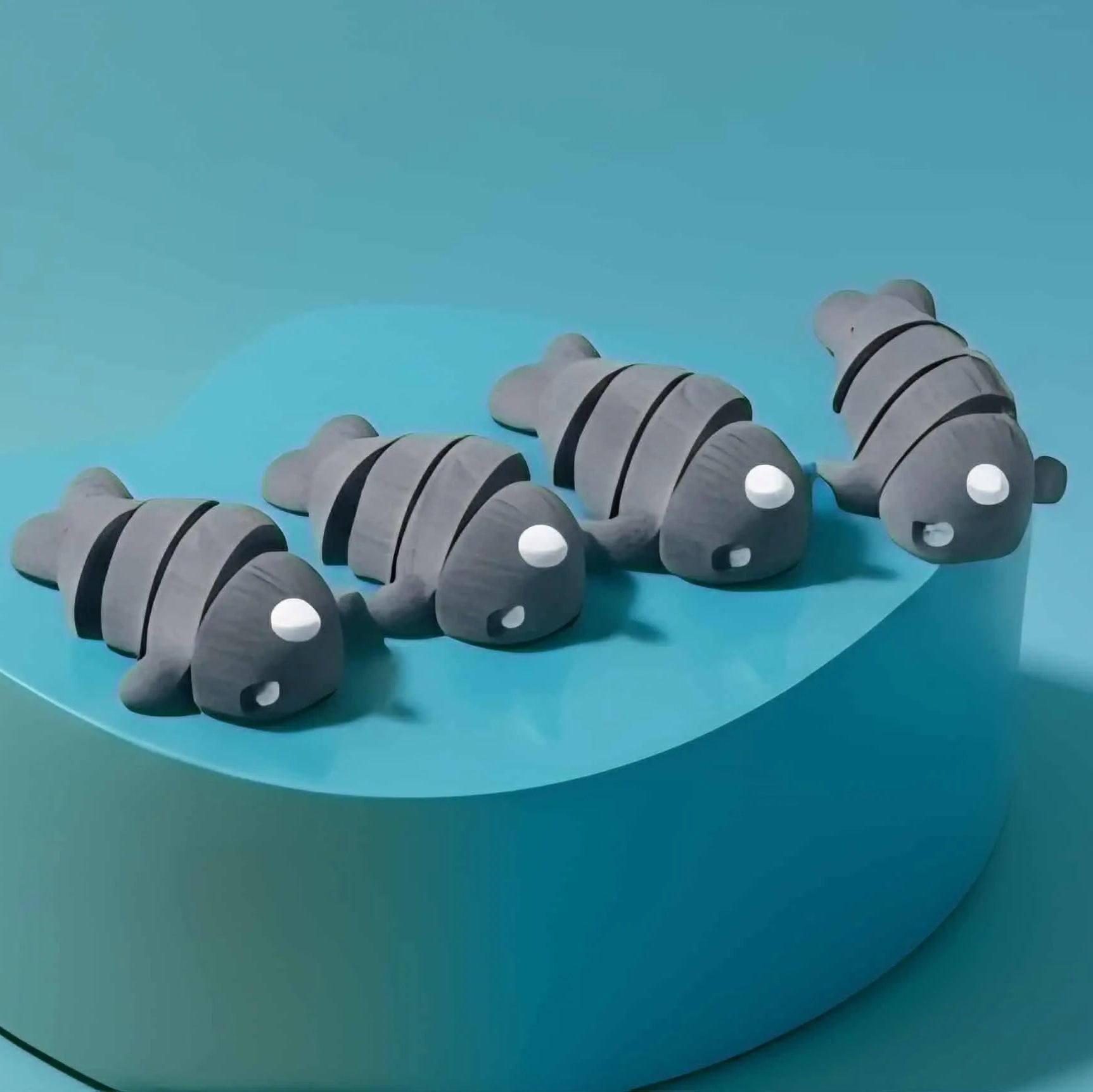 Set of gray fish-shaped objects on a teal heart-shaped base against a teal background