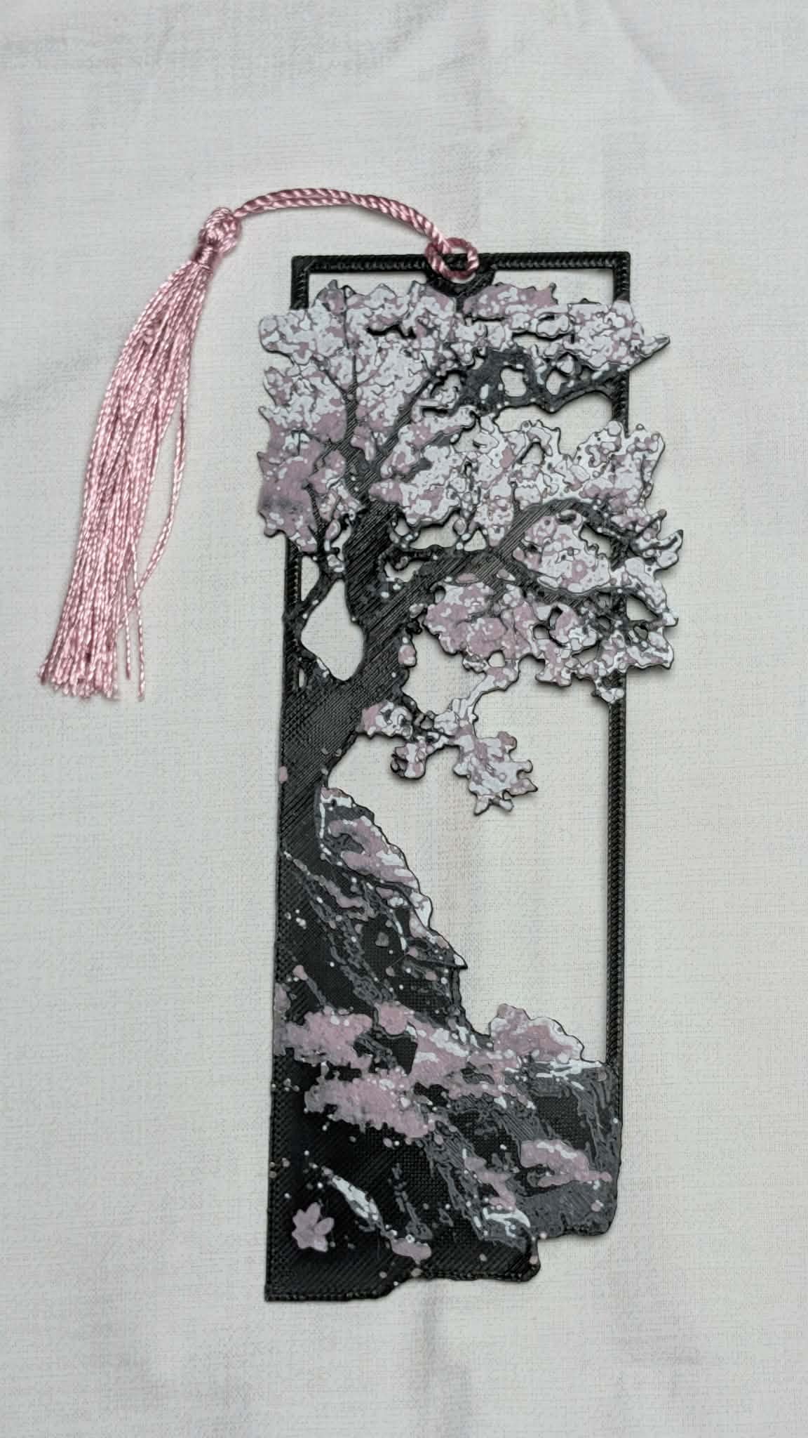Decorative bookmark with cherry blossom design on a light gray background