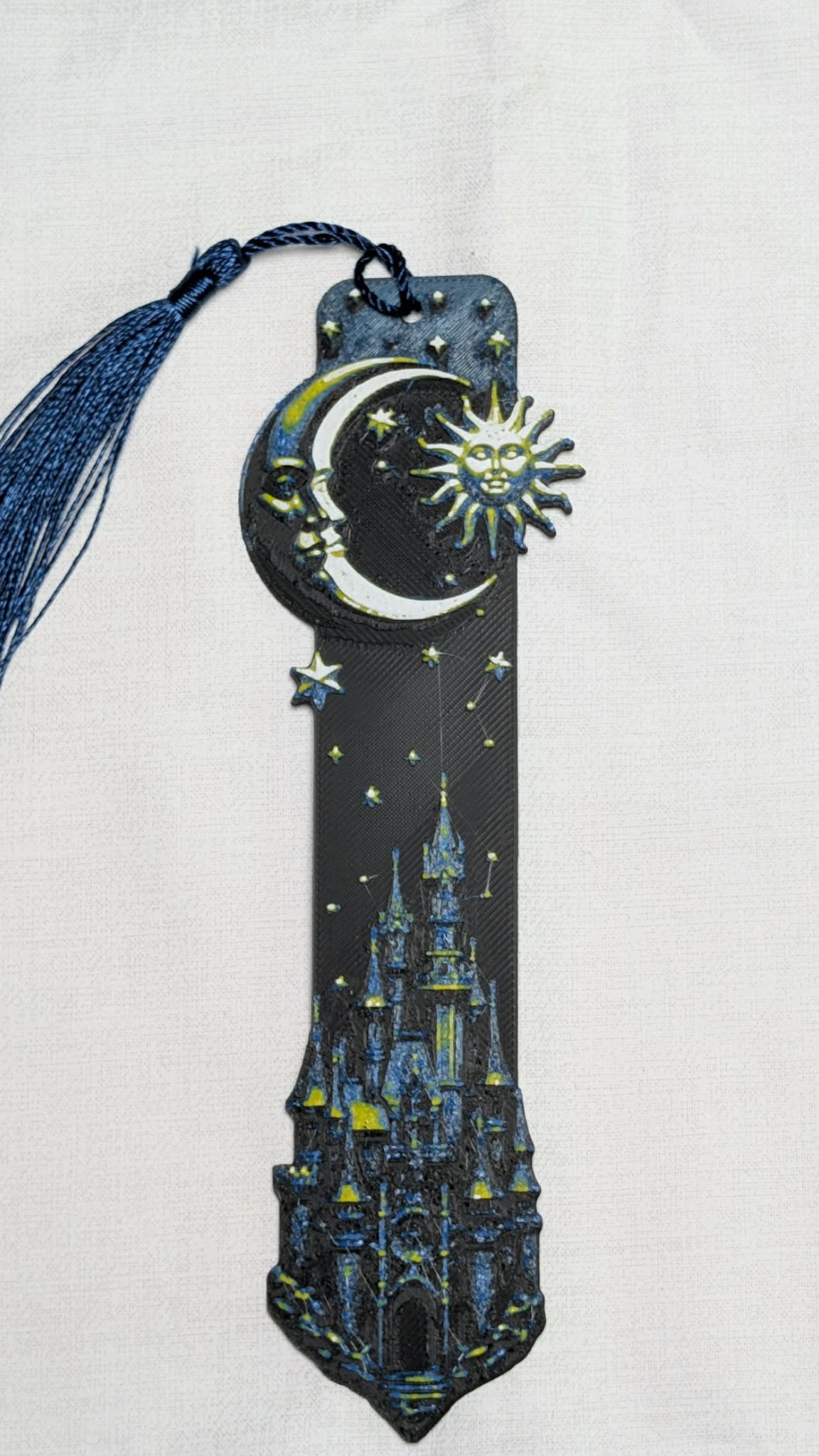 Decorative bookmark with celestial design and castle illustration on a white background
