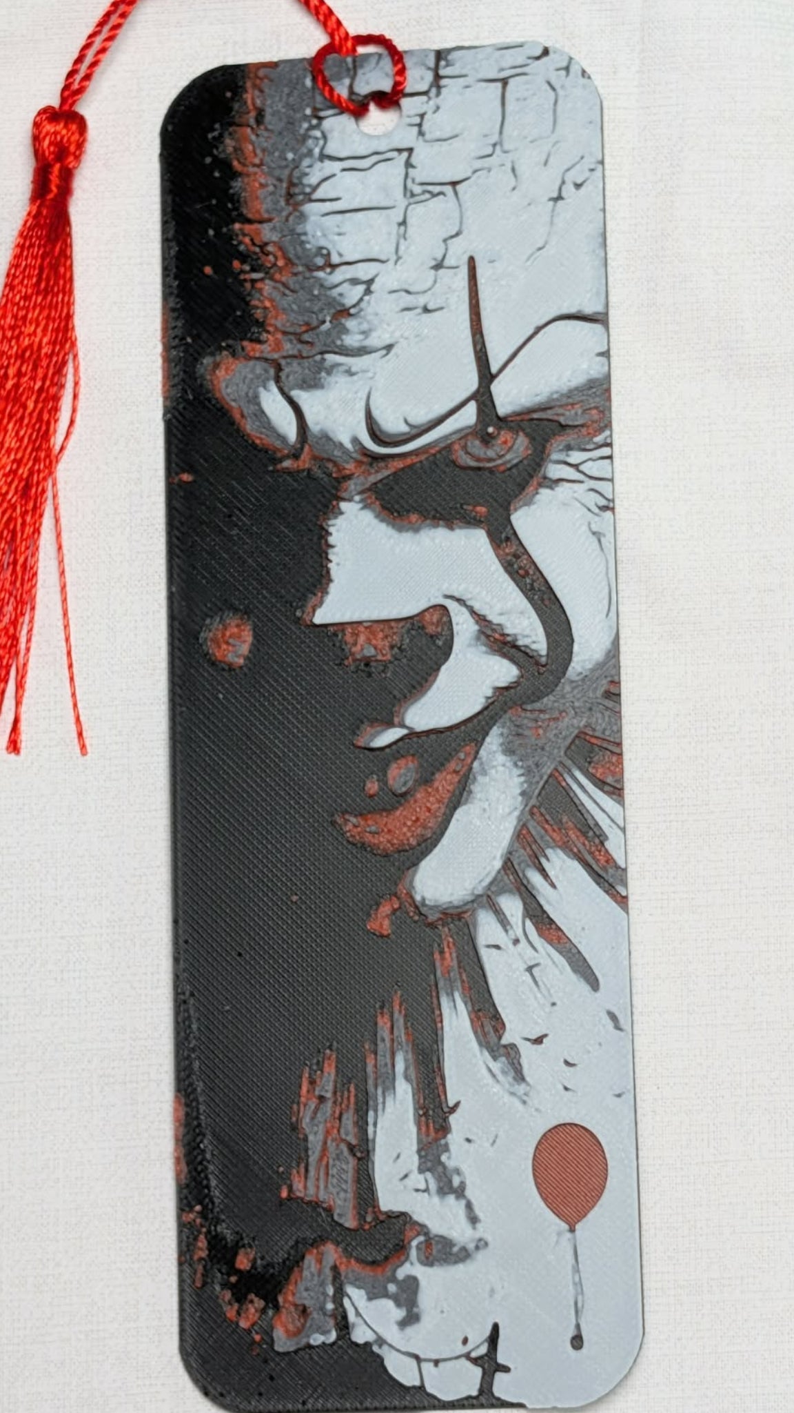 Bookmark with artistic design of a face on a white background