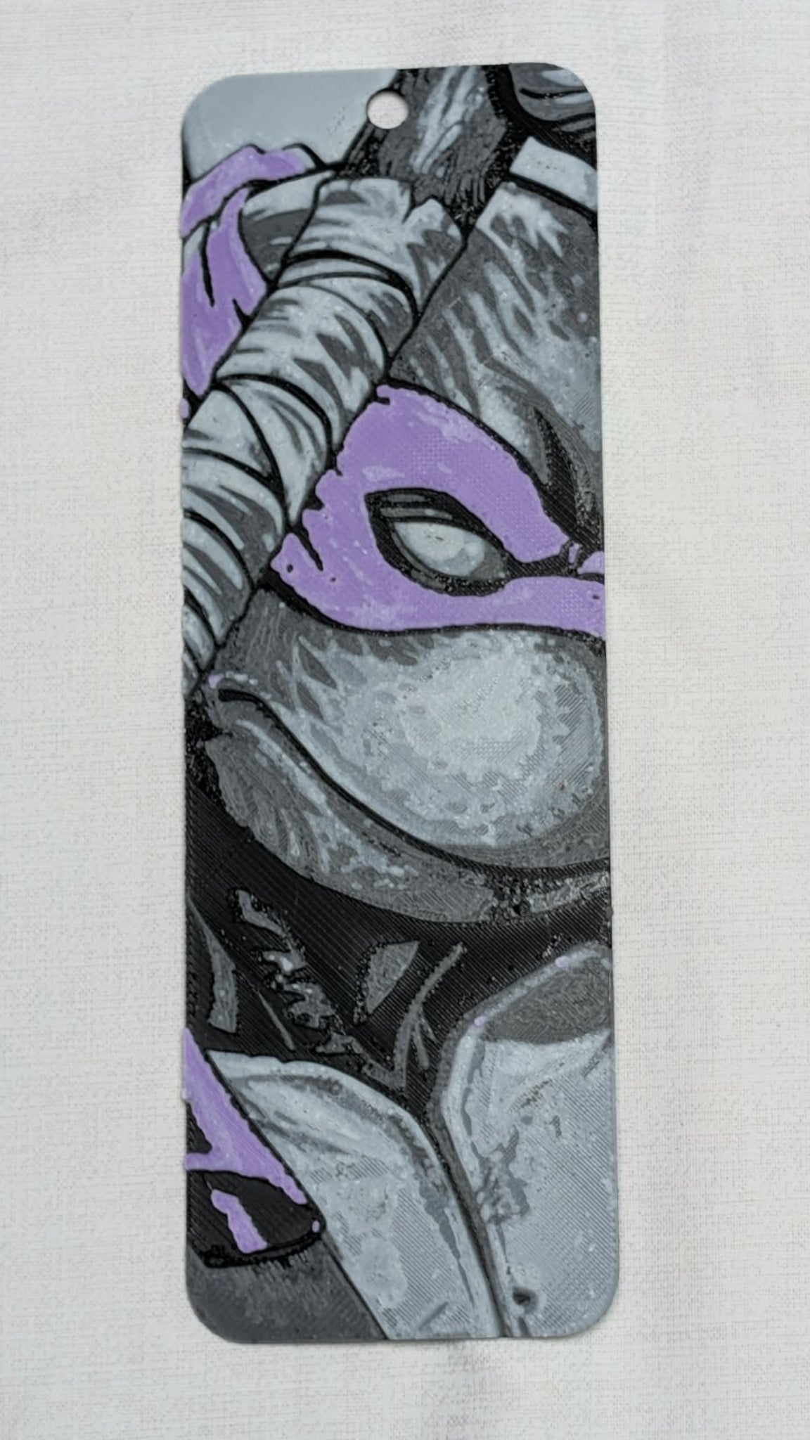 Phone case with a stylized illustration of a character wearing a mask on a light gray background