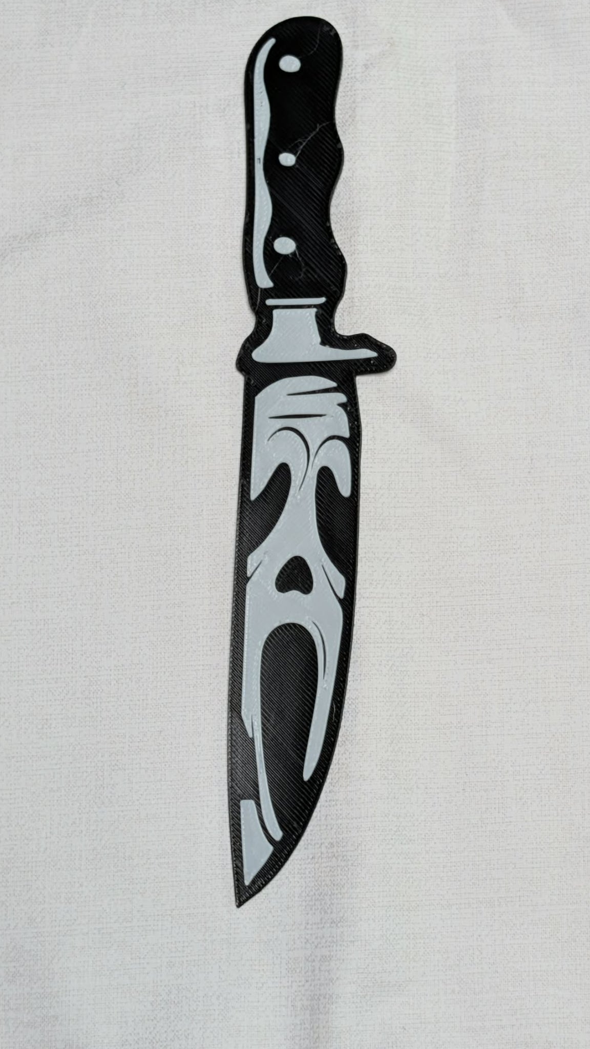 Black knife design on a white shirt