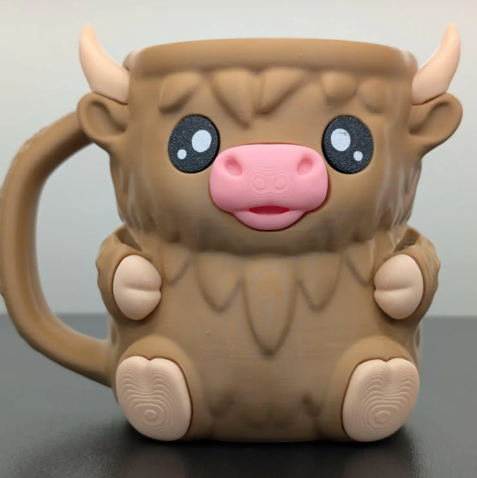 Cute cow-shaped mug with cartoon face on a gray background