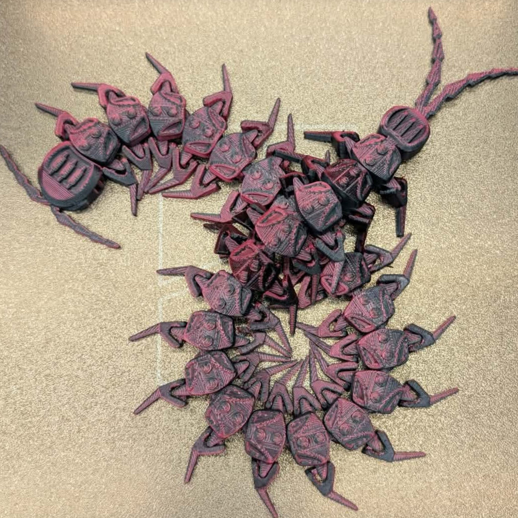 Collection of red and black beetle-like figures on a beige background