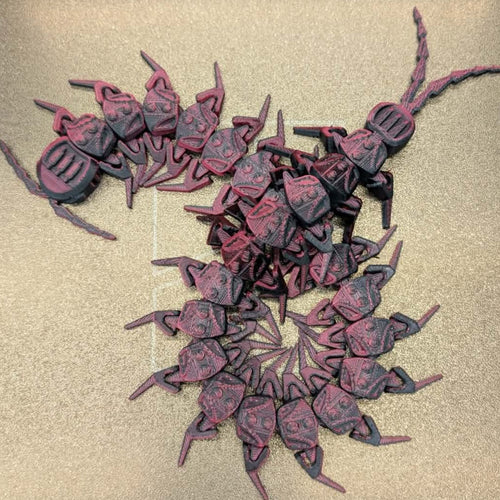 Collection of red and black beetle-like figures on a beige background