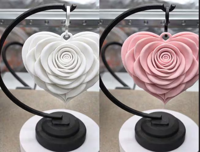Heart-shaped earrings with rose design on a stand