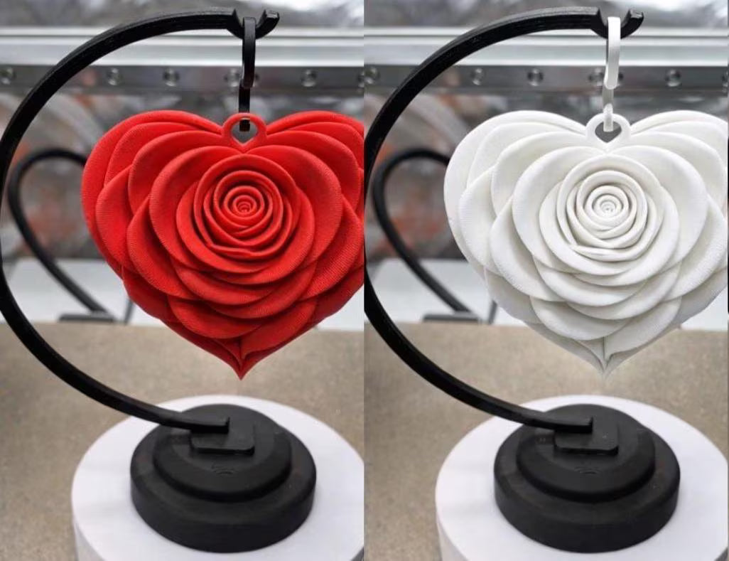 Red and white heart-shaped rose decorations on stands with blurred background