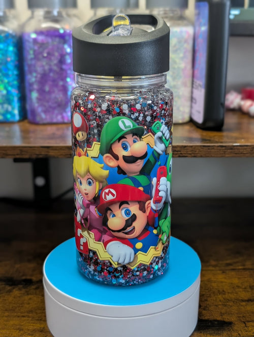 Glittery water bottle with Super Mario characters on a wooden surface