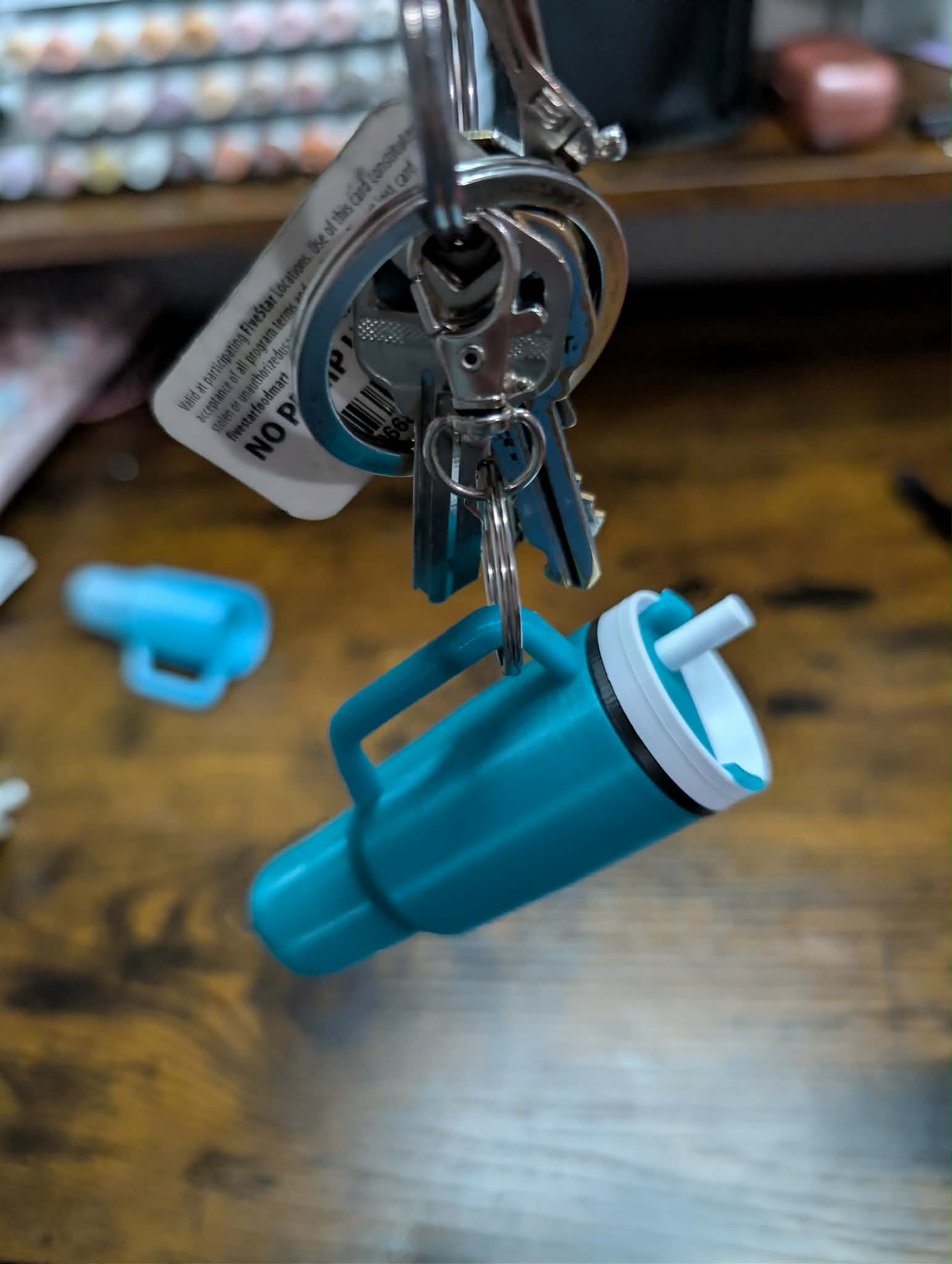 Mini tumbler keychain attached to keys demonstrating use