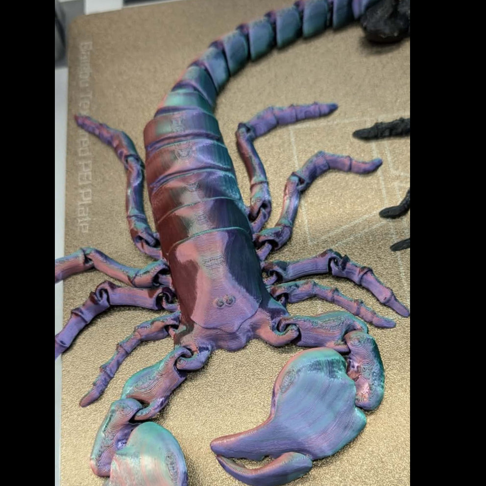 Colorful scorpion model on a beige surface