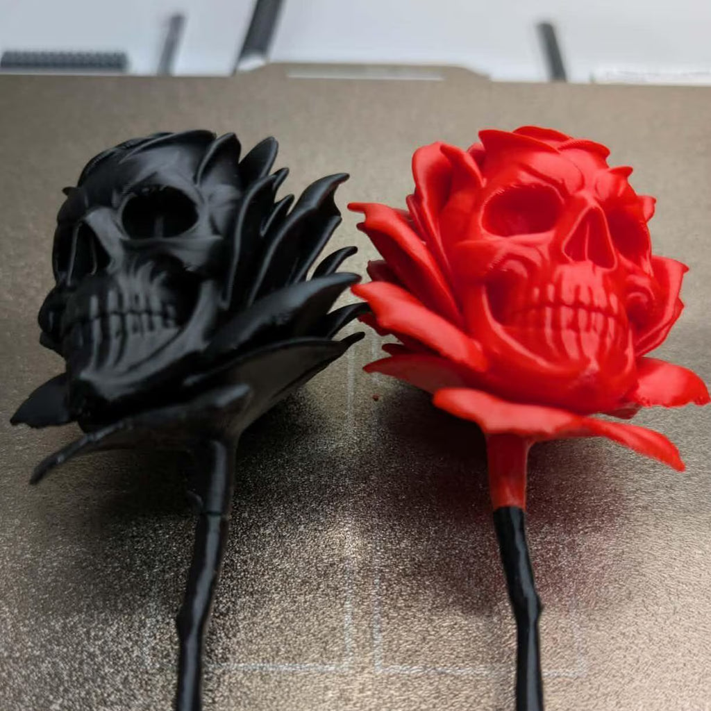 Black and red skull-shaped roses on a textured surface