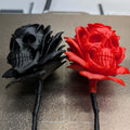 Black and red skull-shaped roses on a textured surface