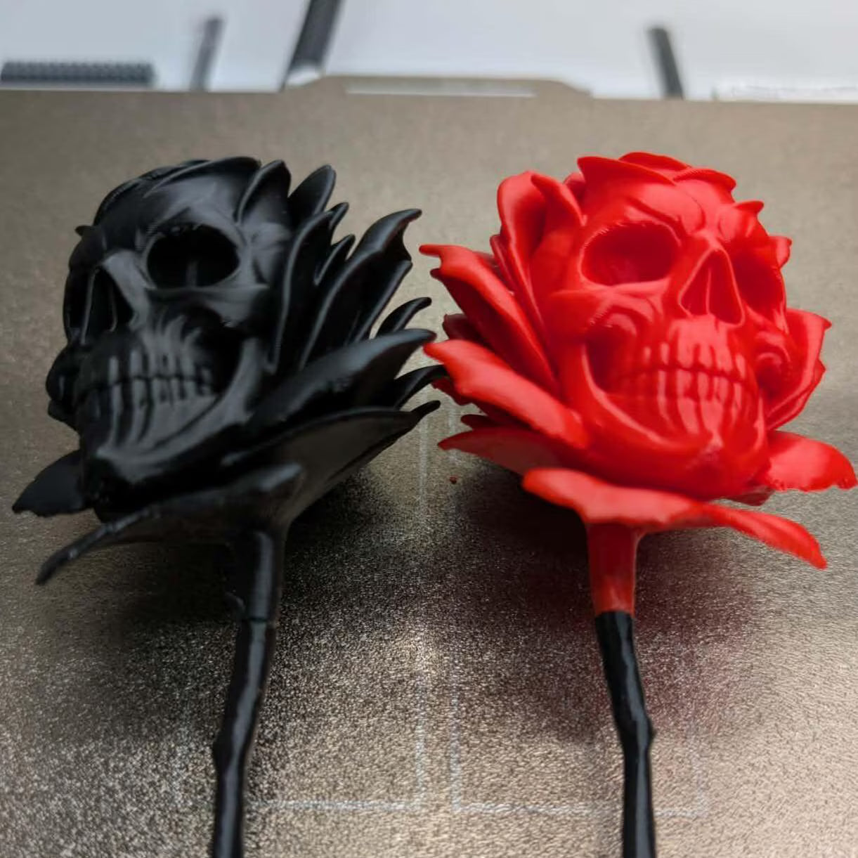 Black and red skull-shaped roses on a textured surface