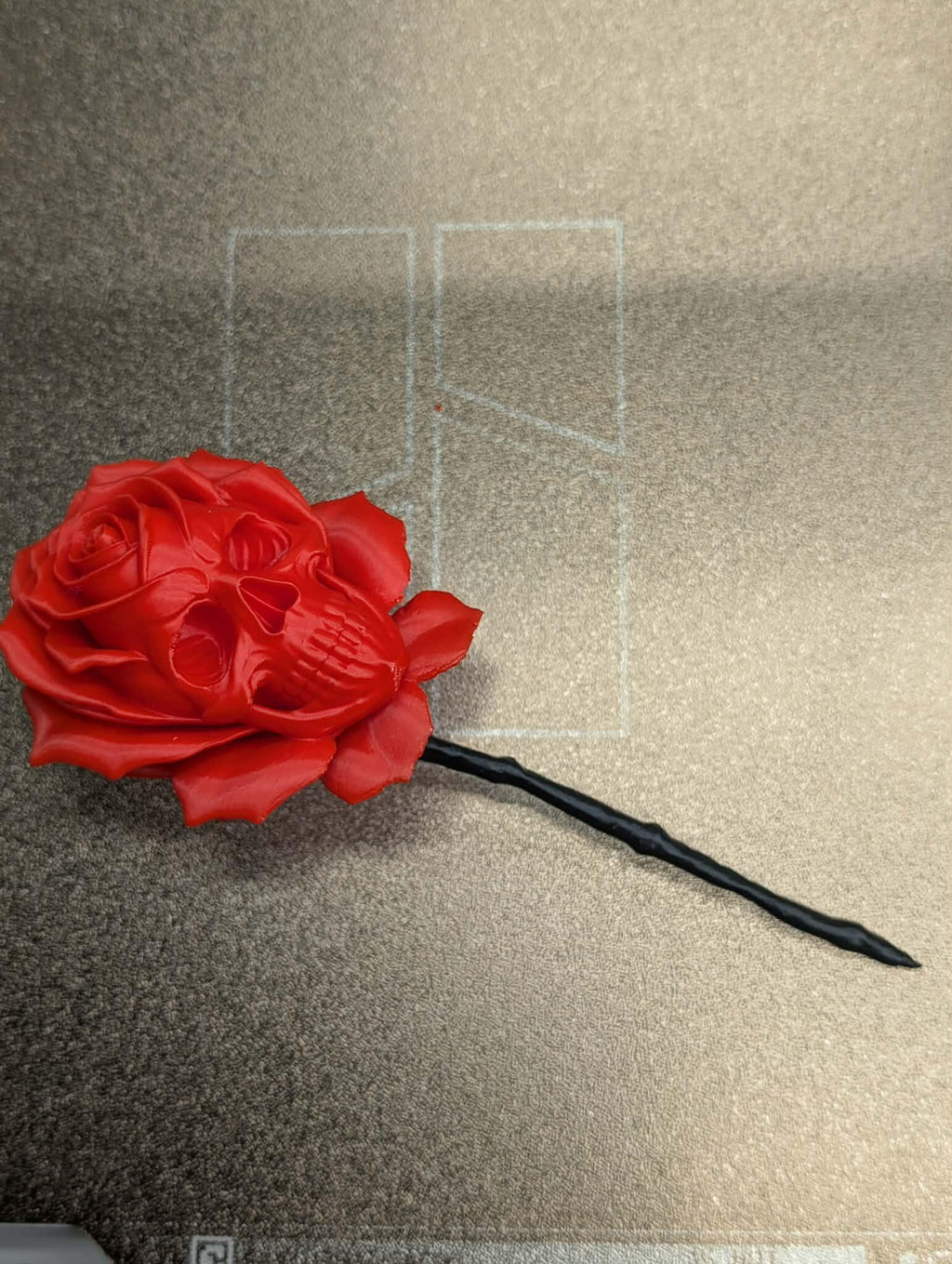 Red rose-shaped object on a textured surface