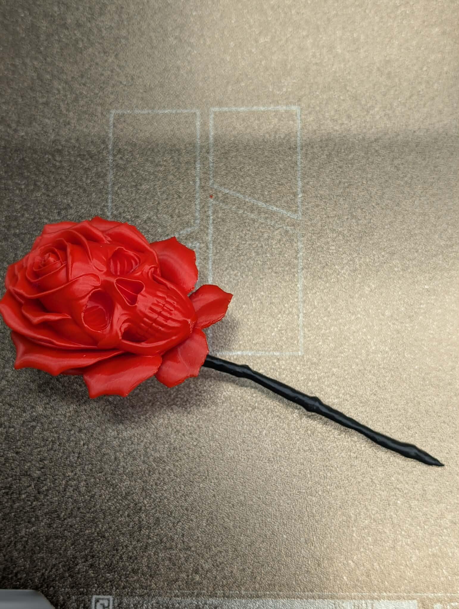 Red rose-shaped object on a textured surface