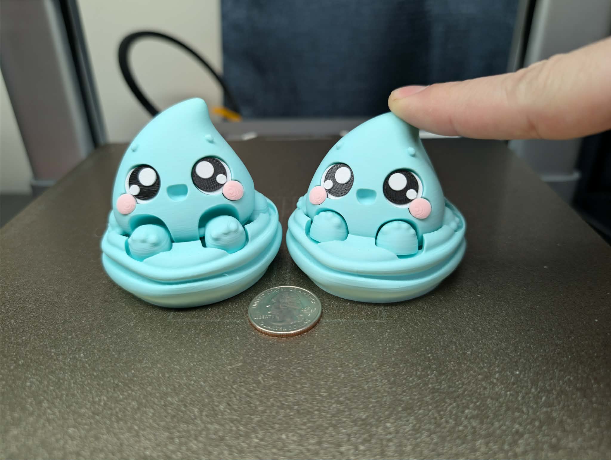 Alternate water elemental fidget clicker 3D printed desk toy with blue water droplet character